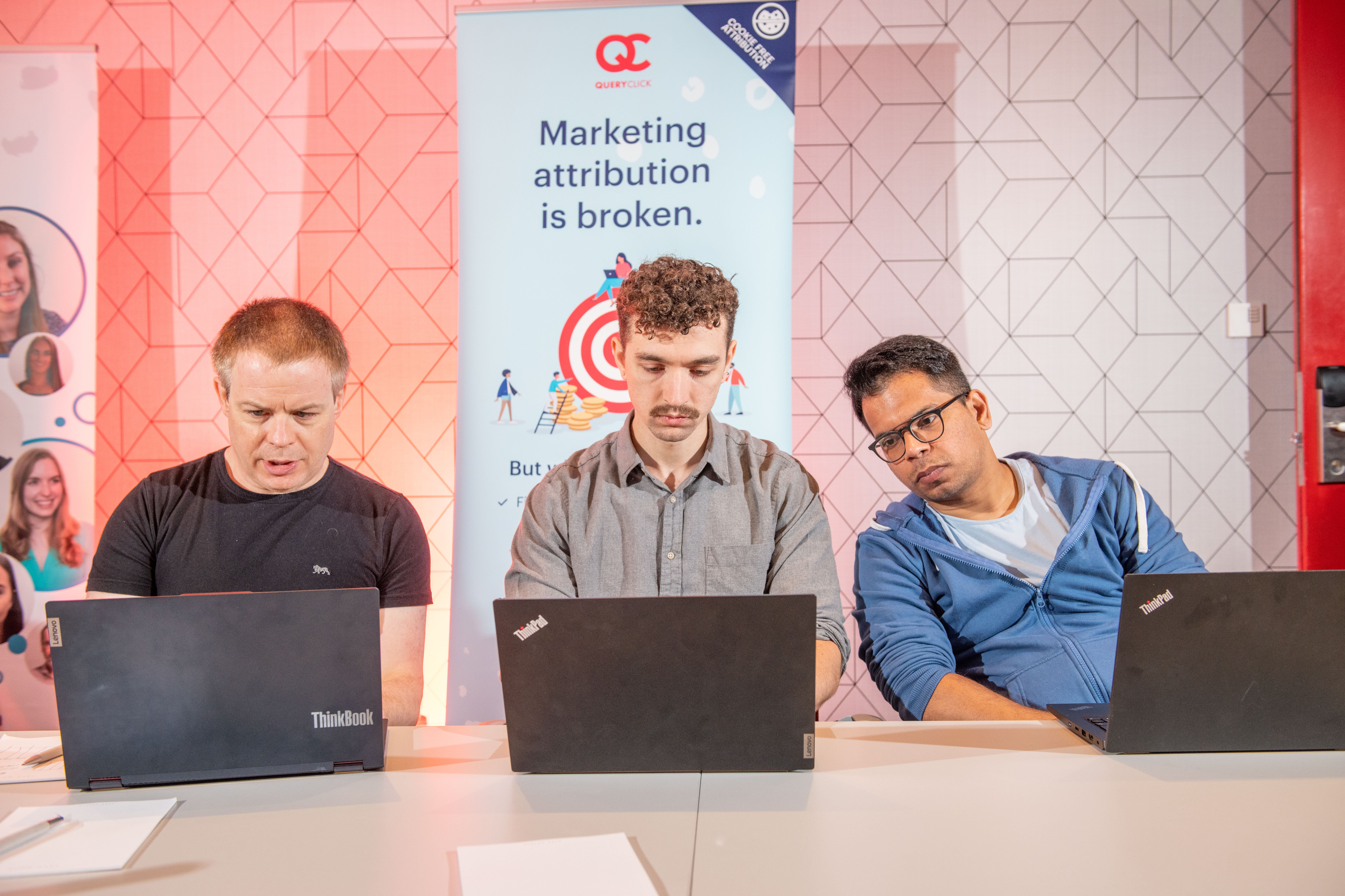 QueryClick team reviewing data on laptops